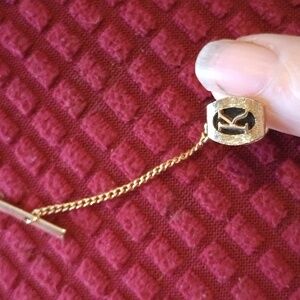 Gold tie tack with K monogram
